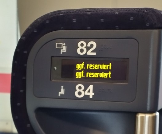 Picture of a train seat showing a standard legend indicating that the seat could be reserved (