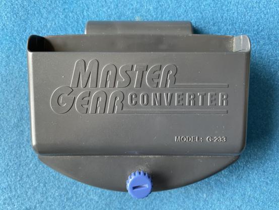 Master Gear Converter which has a cartridge slot for Master System Games and can be inserted into a Game Gear to play Master System games on it.