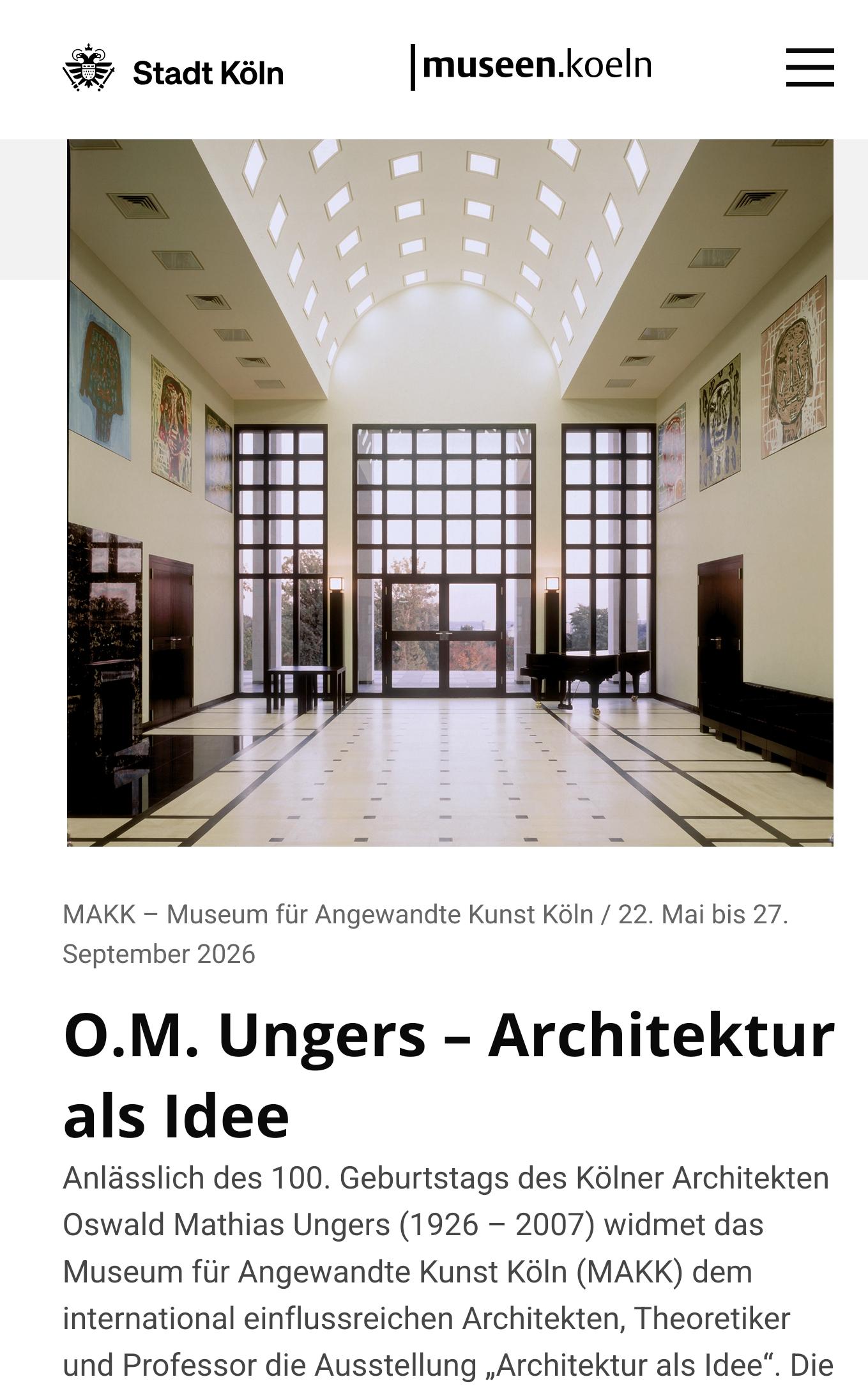 Der Screenshot der Website der Kölner Museen zeigt eine von Ungers entworfene Eingangshalle. Diese Halle verfügt über eine gewölbte Decke, die mit Lichtstrahlern ausgestattet und hell erleuchtet ist. Die Stirnseite bildet eine Fensterwand, die im oberen Bereich die charakteristischen Kassettenfenster von O.M. Ungers aufweist. Darunter befindet sich eine ebenfalls quadratisch geteilte, zweiflügelige Tür.